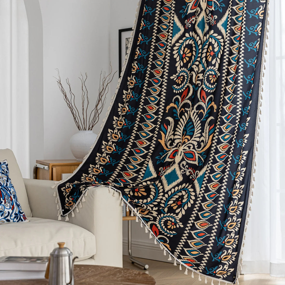 Luxurious bohemian-style curtain featuring a bold black base with intricate beige, red, and teal floral and geometric patterns, finished with elegant tassel trim — perfect for adding vibrant charm and cultural flair to your home décor.