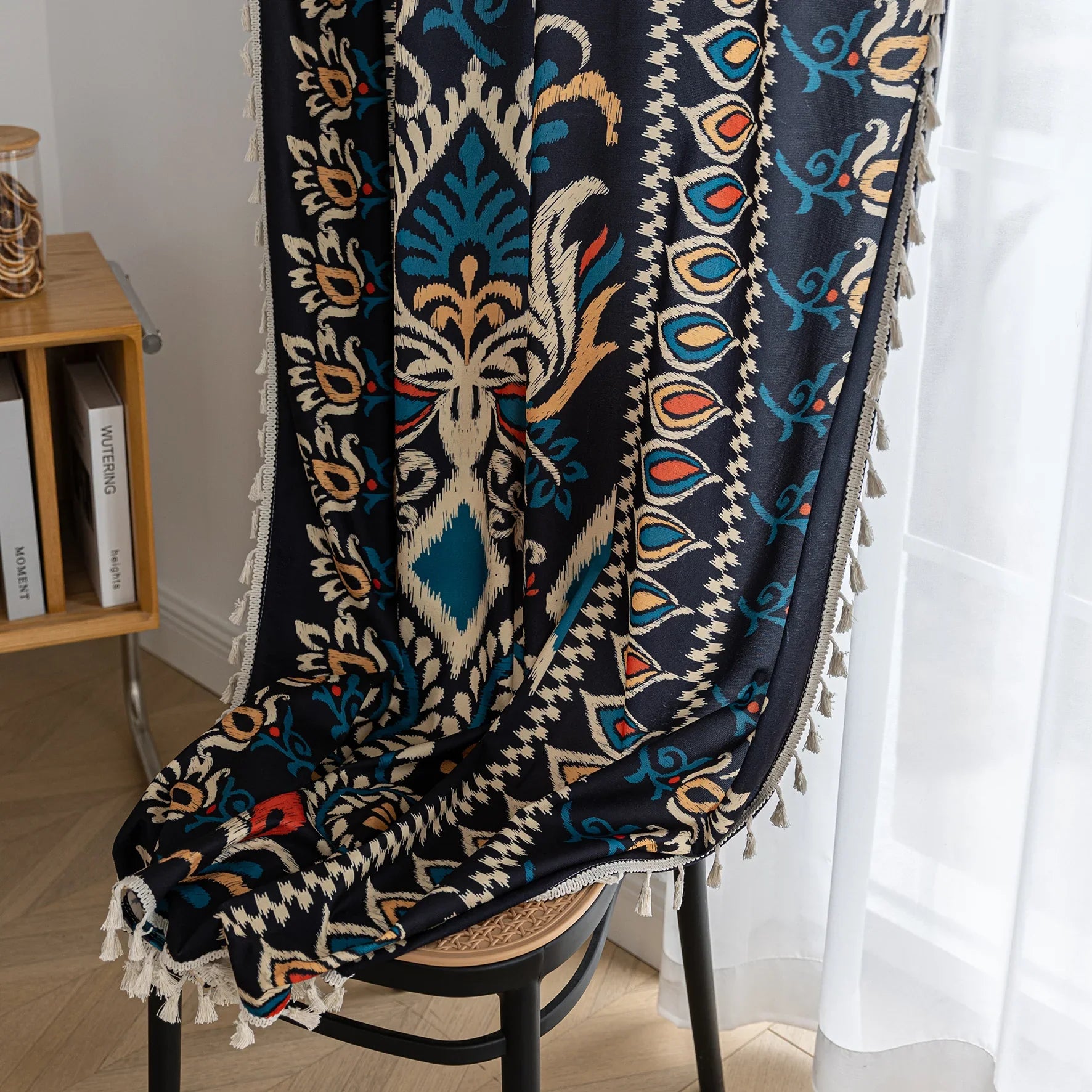 Luxurious bohemian-style curtain featuring a bold black base with intricate beige, red, and teal floral and geometric patterns, finished with elegant tassel trim — perfect for adding vibrant charm and cultural flair to your home décor.