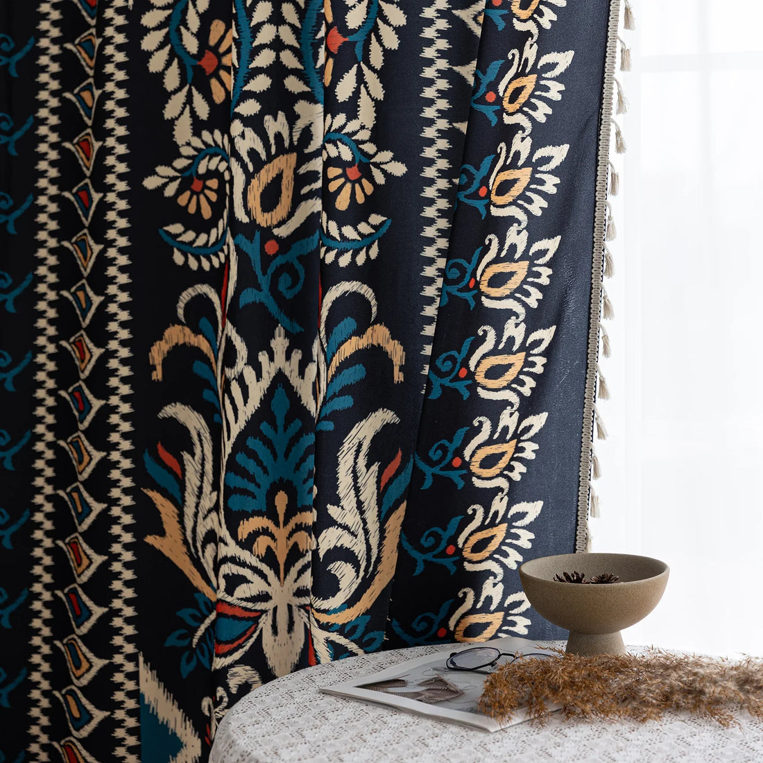 Luxurious bohemian-style curtain featuring a bold black base with intricate beige, red, and teal floral and geometric patterns, finished with elegant tassel trim — perfect for adding vibrant charm and cultural flair to your home décor.
