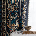 Luxurious bohemian-style curtain featuring a bold black base with intricate beige, red, and teal floral and geometric patterns, finished with elegant tassel trim — perfect for adding vibrant charm and cultural flair to your home décor.