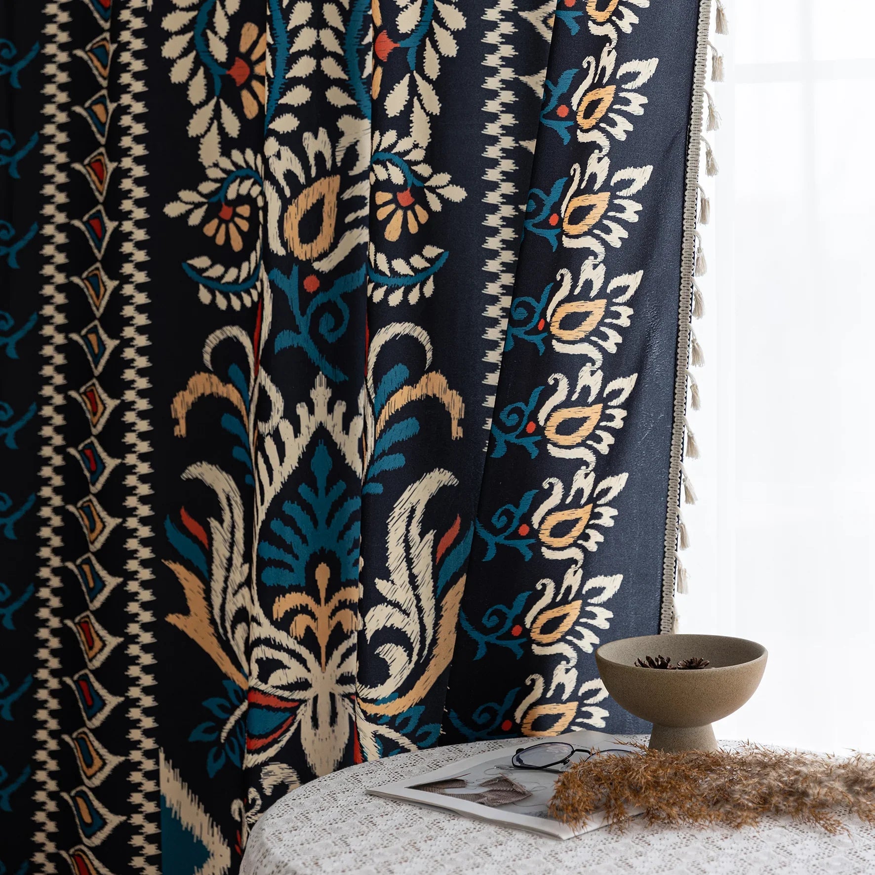 Luxurious bohemian-style curtain featuring a bold black base with intricate beige, red, and teal floral and geometric patterns, finished with elegant tassel trim — perfect for adding vibrant charm and cultural flair to your home décor.