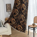 Stylish ethnic-inspired curtain with bold geometric patterns in warm golden-orange tones on a deep black background, accented with delicate tassel trim — ideal for adding a modern tribal touch and cozy elegance to your living space.