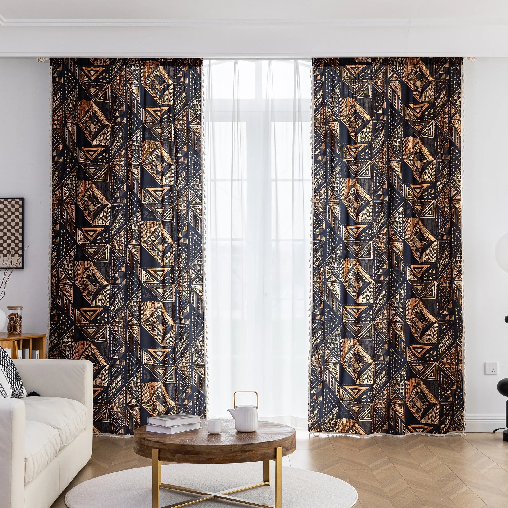 Stylish ethnic-inspired curtain with bold geometric patterns in warm golden-orange tones on a deep black background, accented with delicate tassel trim — ideal for adding a modern tribal touch and cozy elegance to your living space.