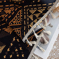 Stylish ethnic-inspired curtain with bold geometric patterns in warm golden-orange tones on a deep black background, accented with delicate tassel trim — ideal for adding a modern tribal touch and cozy elegance to your living space.