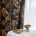Stylish ethnic-inspired curtain with bold geometric patterns in warm golden-orange tones on a deep black background, accented with delicate tassel trim — ideal for adding a modern tribal touch and cozy elegance to your living space.