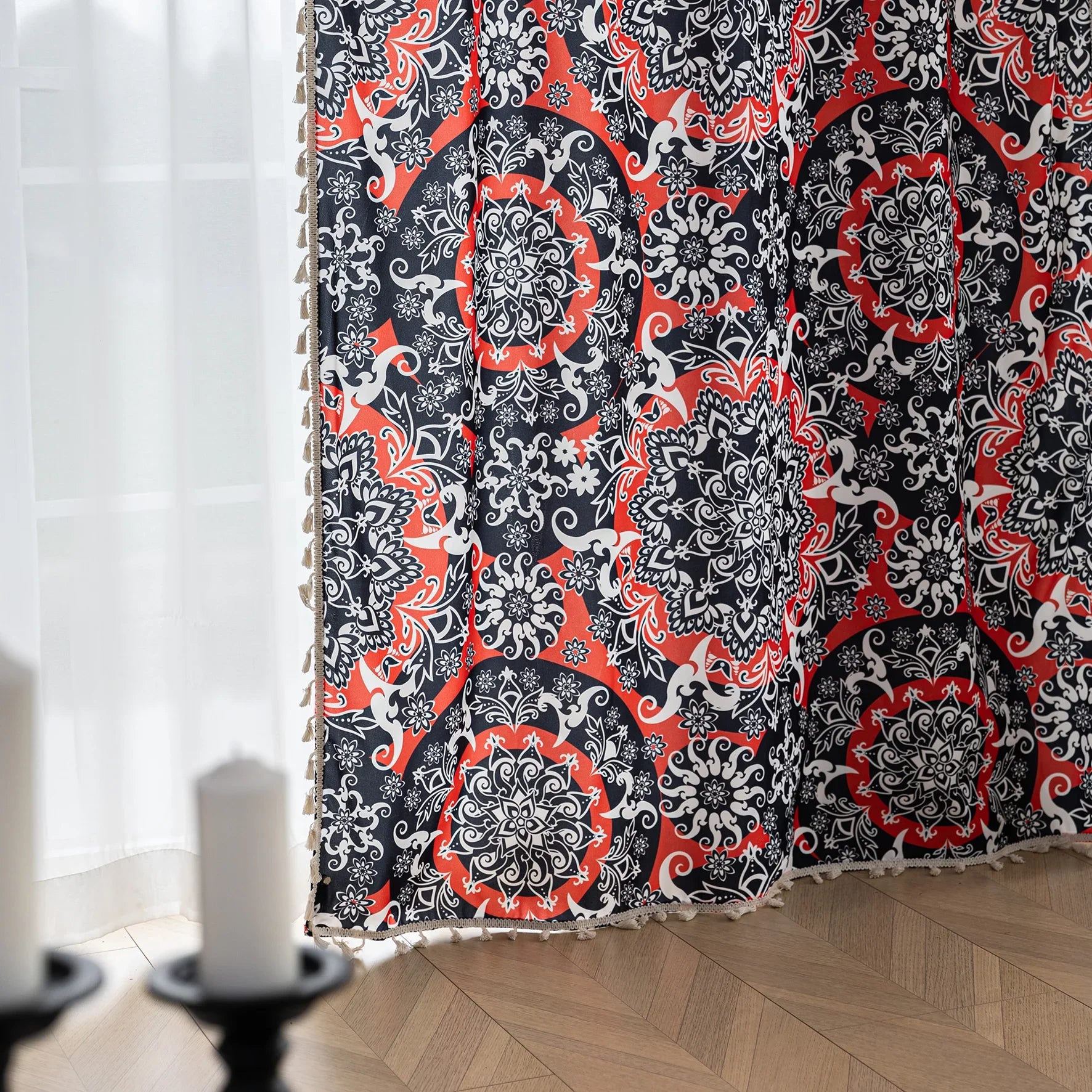 Vibrant bohemian-style curtain with intricate mandala patterns in striking red, black, and white tones, accented with swirling floral details and finished with elegant white tassel trim — perfect for adding bold artistic flair and cultural charm to any living space.