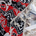 Vibrant bohemian-style curtain with intricate mandala patterns in striking red, black, and white tones, accented with swirling floral details and finished with elegant white tassel trim — perfect for adding bold artistic flair and cultural charm to any living space.