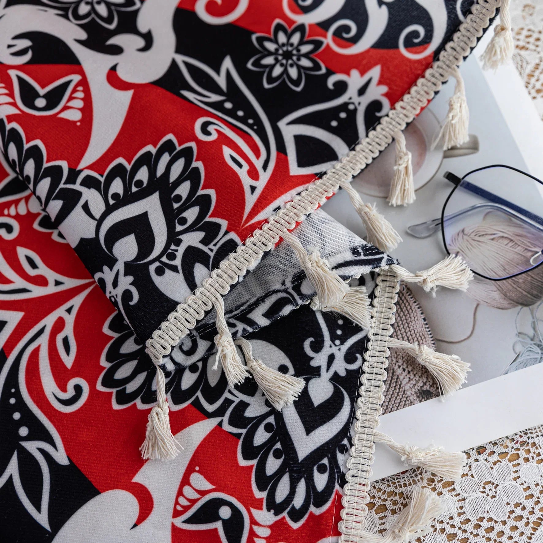 Vibrant bohemian-style curtain with intricate mandala patterns in striking red, black, and white tones, accented with swirling floral details and finished with elegant white tassel trim — perfect for adding bold artistic flair and cultural charm to any living space.