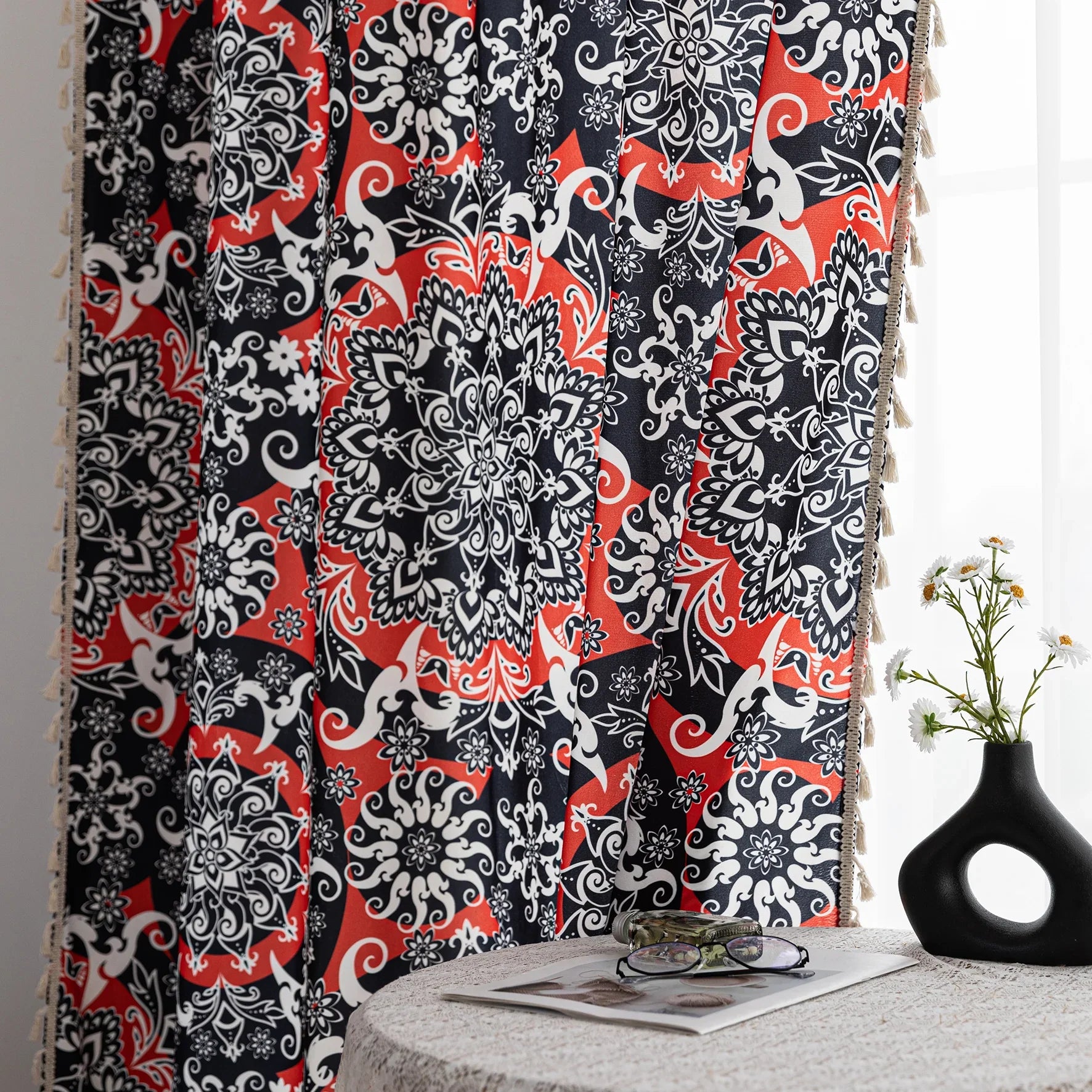 Vibrant bohemian-style curtain with intricate mandala patterns in striking red, black, and white tones, accented with swirling floral details and finished with elegant white tassel trim — perfect for adding bold artistic flair and cultural charm to any living space.