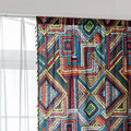 Vibrant geometric bohemian curtain with bold multicolor diamond patterns, featuring intricate woven-style designs and colorful tassel trim — ideal for adding a lively, artistic statement to any room décor.