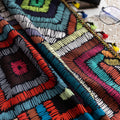 Vibrant geometric bohemian curtain with bold multicolor diamond patterns, featuring intricate woven-style designs and colorful tassel trim — ideal for adding a lively, artistic statement to any room décor.