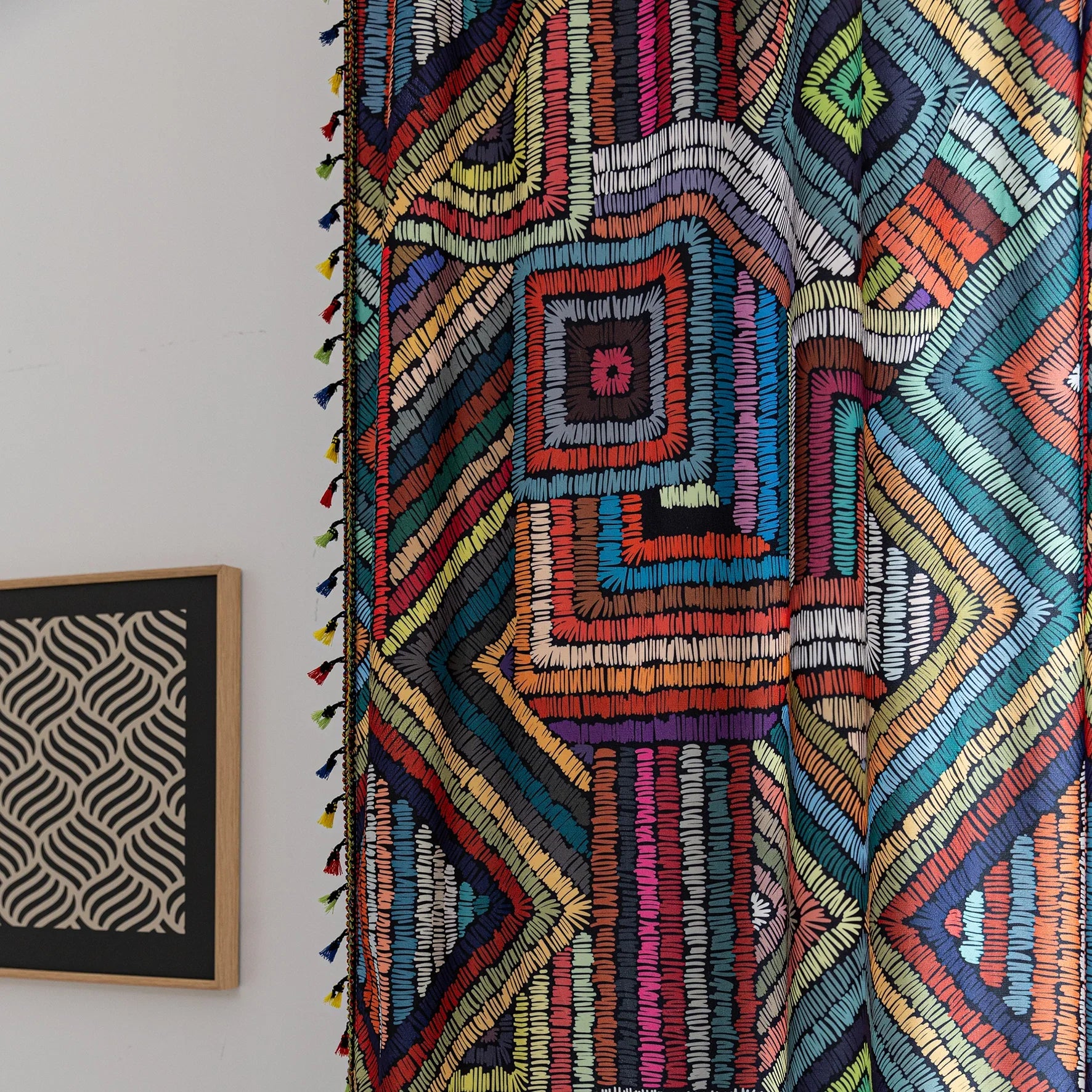 Vibrant geometric bohemian curtain with bold multicolor diamond patterns, featuring intricate woven-style designs and colorful tassel trim — ideal for adding a lively, artistic statement to any room décor.