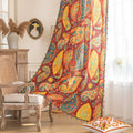 Vibrant bohemian curtain with an intricate paisley pattern in rich red, golden yellow, turquoise, and orange tones, accented with colorful tassel trim — perfect for adding a warm, artistic, and eclectic charm to your living room or bedroom décor.