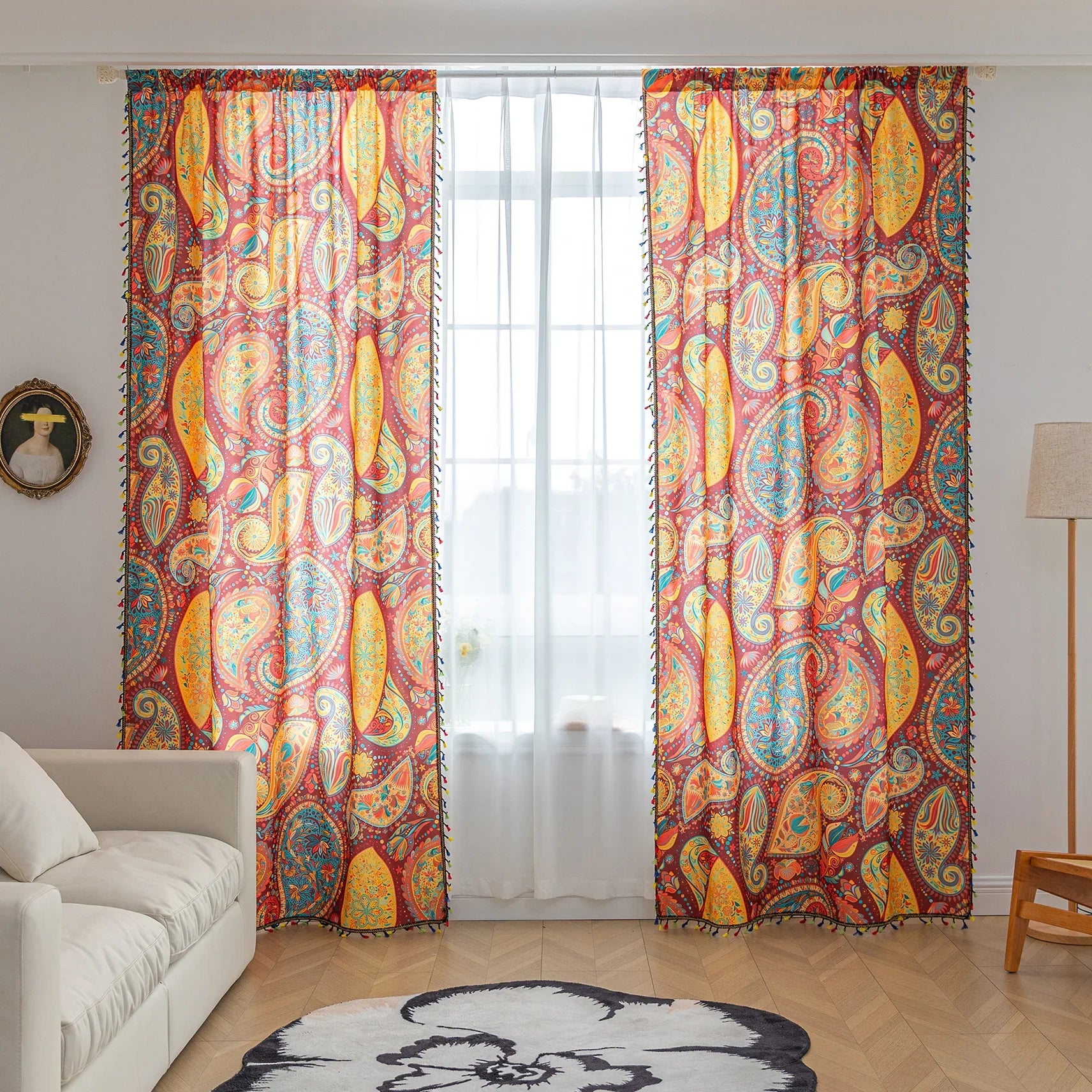 Vibrant bohemian curtain with an intricate paisley pattern in rich red, golden yellow, turquoise, and orange tones, accented with colorful tassel trim — perfect for adding a warm, artistic, and eclectic charm to your living room or bedroom décor.