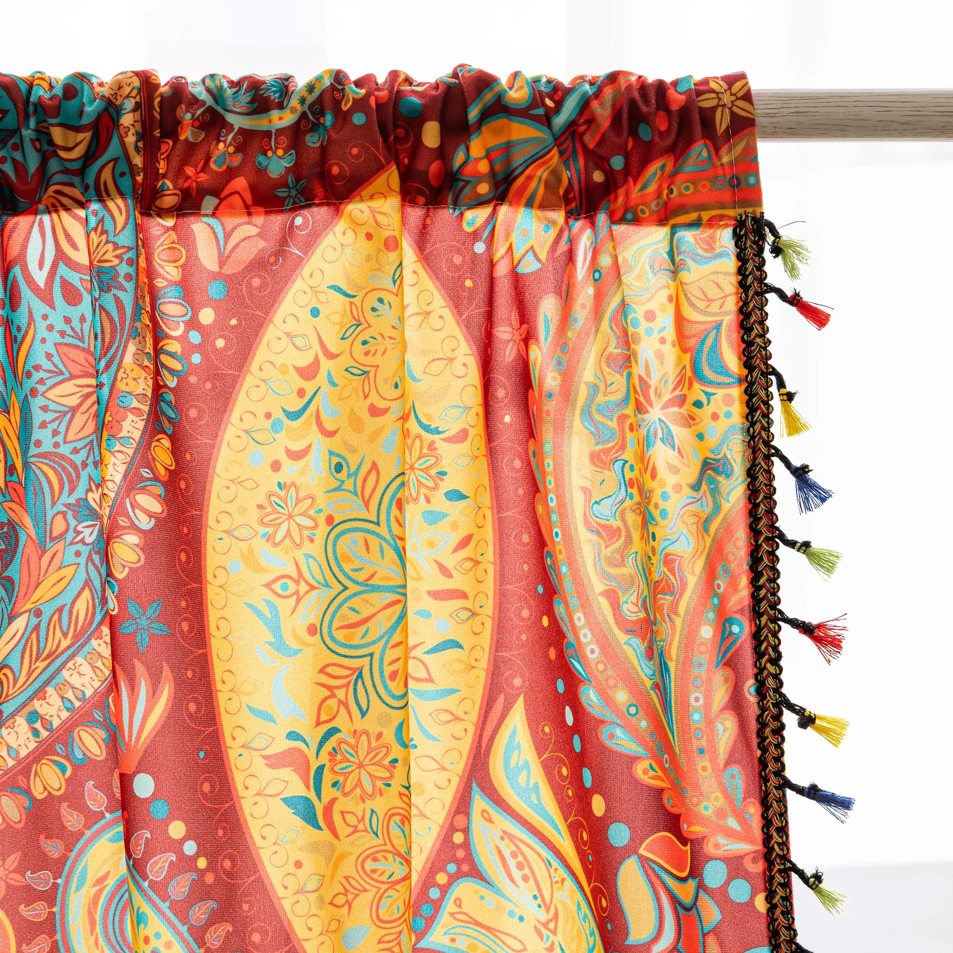 Vibrant bohemian curtain with an intricate paisley pattern in rich red, golden yellow, turquoise, and orange tones, accented with colorful tassel trim — perfect for adding a warm, artistic, and eclectic charm to your living room or bedroom décor.