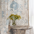 Elegant curtain with a unique hexagon tile-inspired pattern in muted blue, beige, and soft gold tones on a light cream background, finished with delicate fringe trim — perfect for adding a sophisticated, Mediterranean touch to your living space.