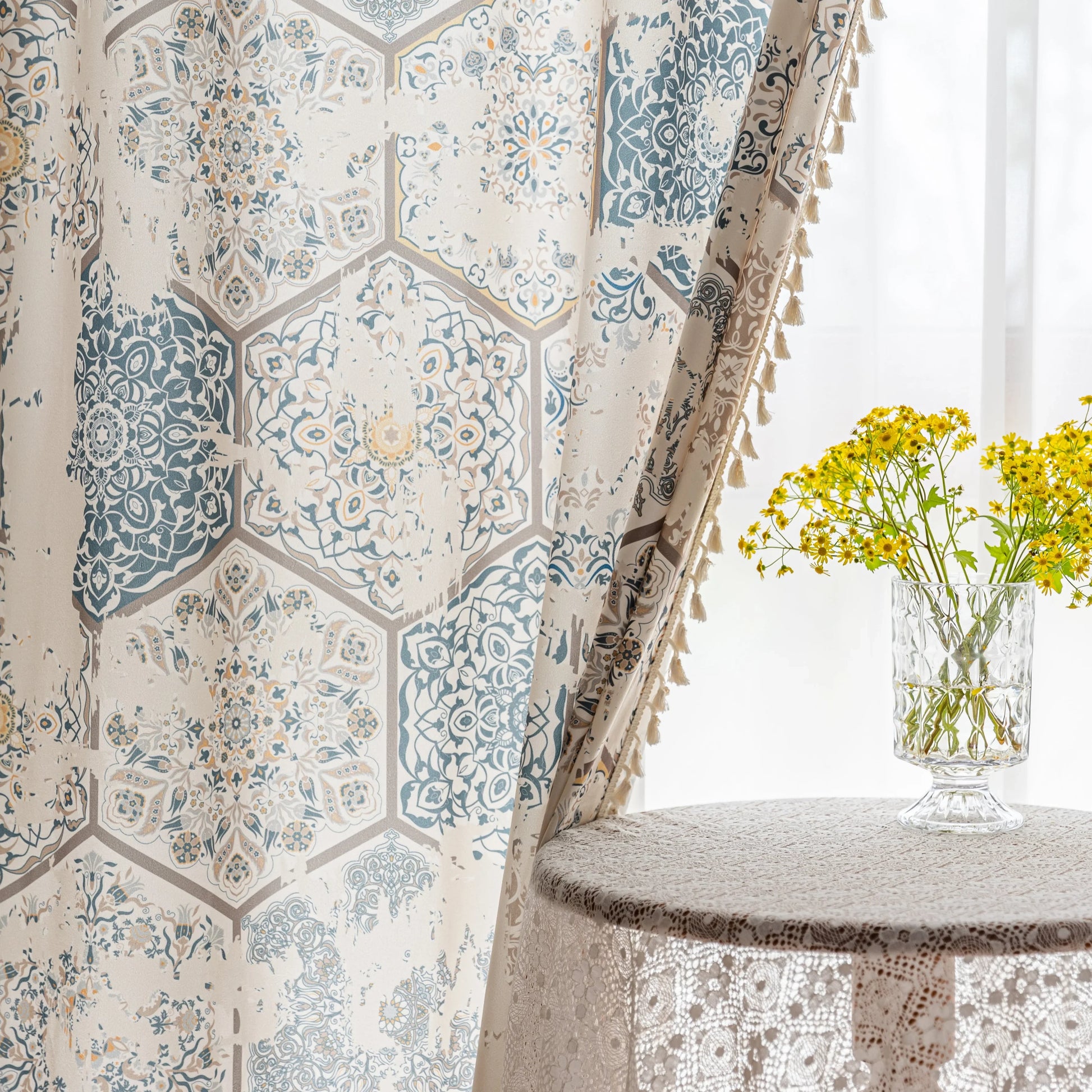 Elegant curtain with a unique hexagon tile-inspired pattern in muted blue, beige, and soft gold tones on a light cream background, finished with delicate fringe trim — perfect for adding a sophisticated, Mediterranean touch to your living space.