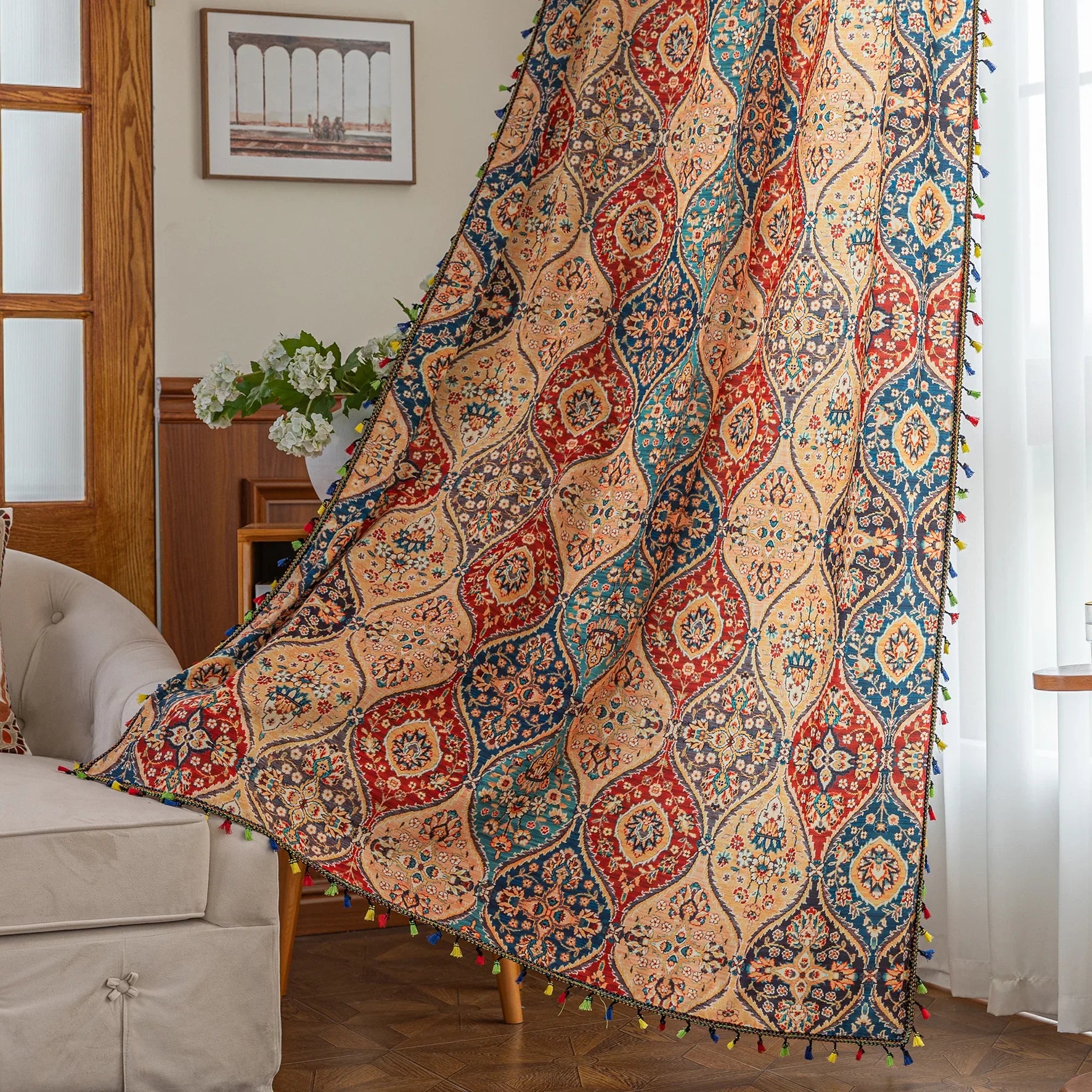 Elegant bohemian curtain featuring a Moroccan-inspired teardrop pattern in warm beige, deep red, and rich blue tones, adorned with intricate floral details and colorful tassel trim — perfect for adding warmth, texture, and global charm to any living space.