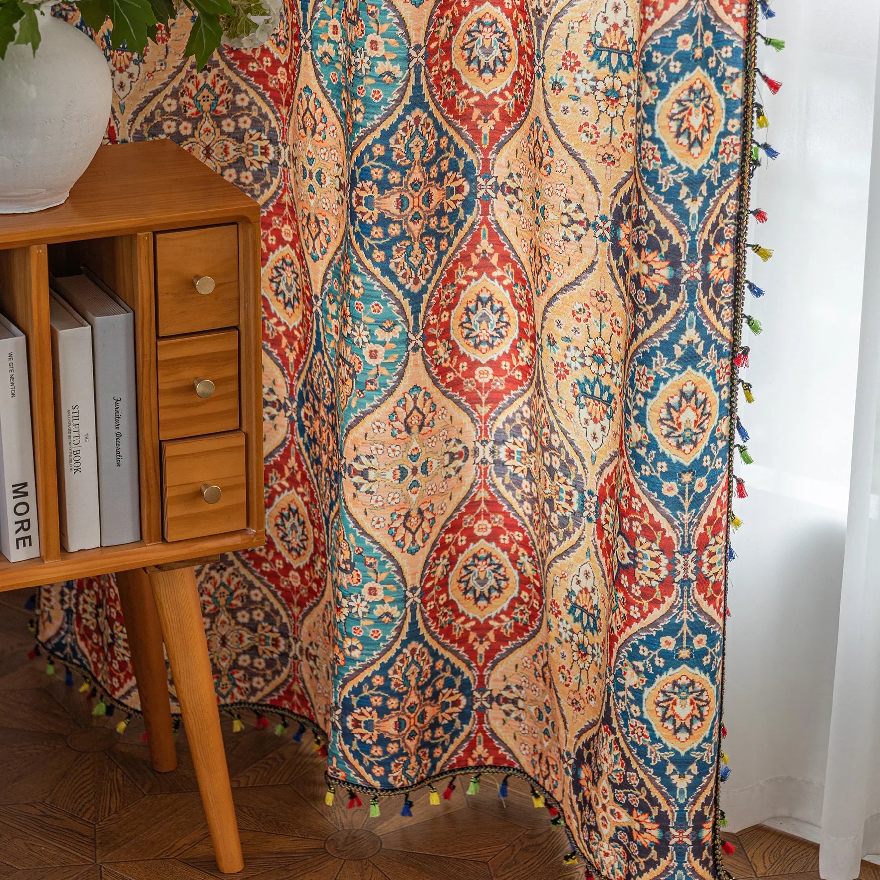 Elegant bohemian curtain featuring a Moroccan-inspired teardrop pattern in warm beige, deep red, and rich blue tones, adorned with intricate floral details and colorful tassel trim — perfect for adding warmth, texture, and global charm to any living space.