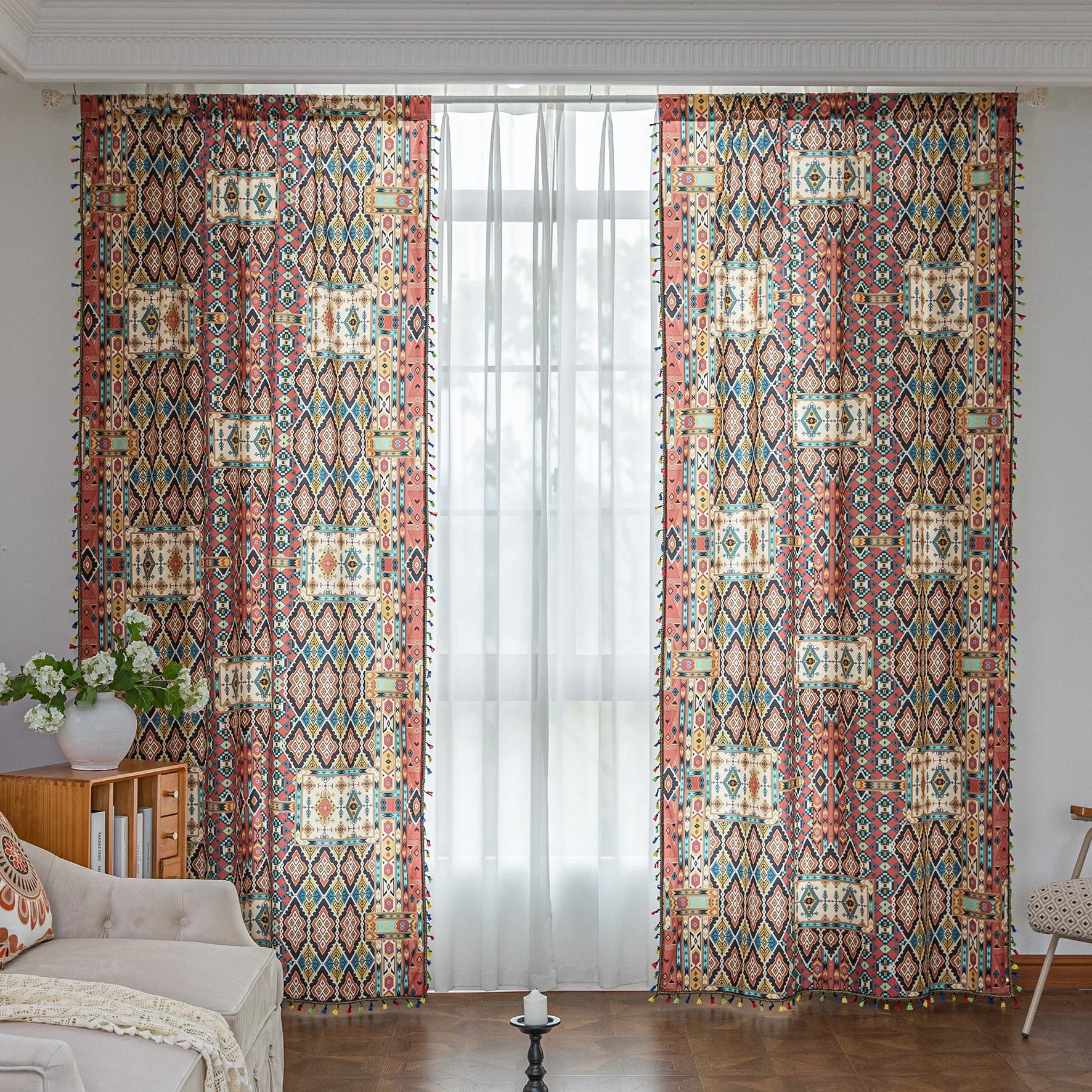 Colorful bohemian curtain with intricate tribal geometric patterns in rich earthy tones of red, beige, turquoise, and gold, accented with multicolor tassels — a perfect choice to add warmth, texture, and global-inspired charm to any room décor.