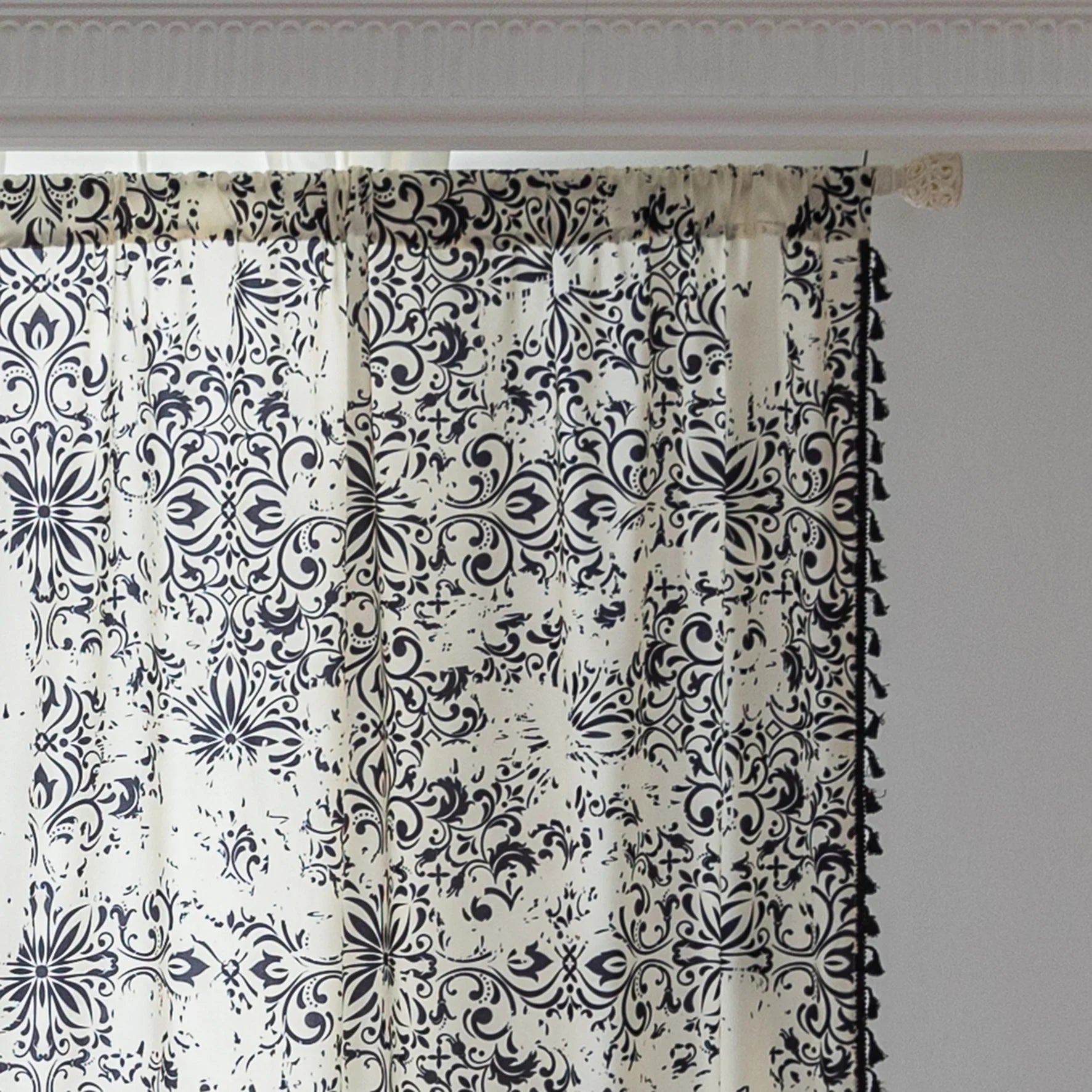 Elegant black and white curtain featuring intricate floral and damask-inspired patterns on a cream background, beautifully finished with matching black tassel trim — perfect for adding timeless sophistication and classic charm to any room décor.