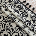 Elegant black and white curtain featuring intricate floral and damask-inspired patterns on a cream background, beautifully finished with matching black tassel trim — perfect for adding timeless sophistication and classic charm to any room décor.