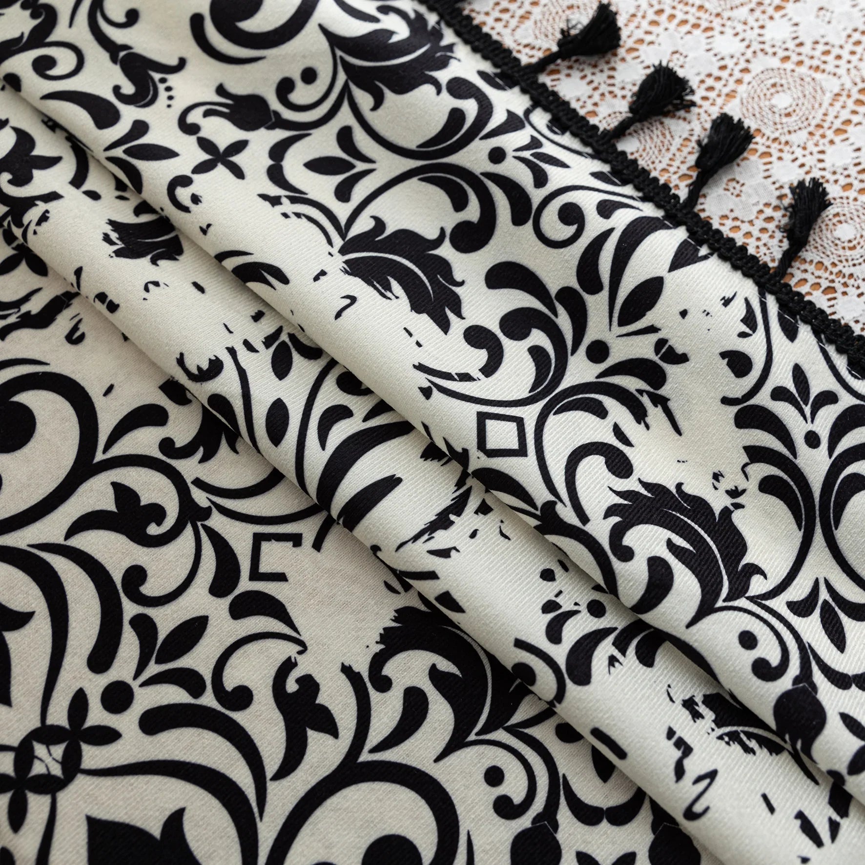 Elegant black and white curtain featuring intricate floral and damask-inspired patterns on a cream background, beautifully finished with matching black tassel trim — perfect for adding timeless sophistication and classic charm to any room décor.