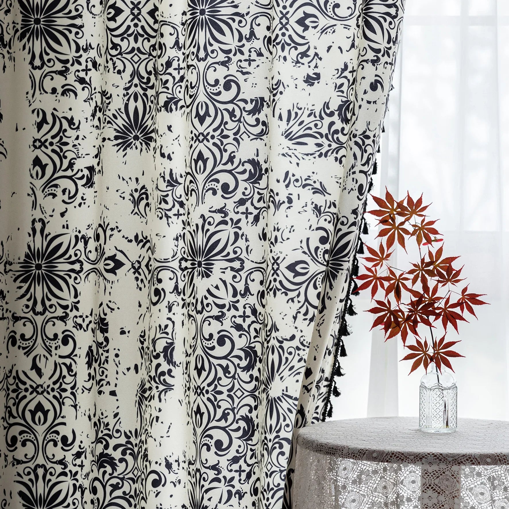 Elegant black and white curtain featuring intricate floral and damask-inspired patterns on a cream background, beautifully finished with matching black tassel trim — perfect for adding timeless sophistication and classic charm to any room décor.