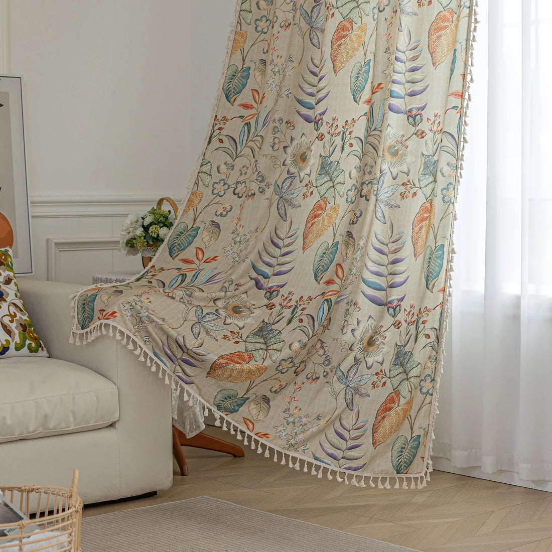 Elegant botanical curtain with a soft beige base, featuring hand-painted style floral and leaf patterns in warm earthy tones and muted pastels, finished with white tassel trim — perfect for bringing a fresh, nature-inspired charm to your home décor.