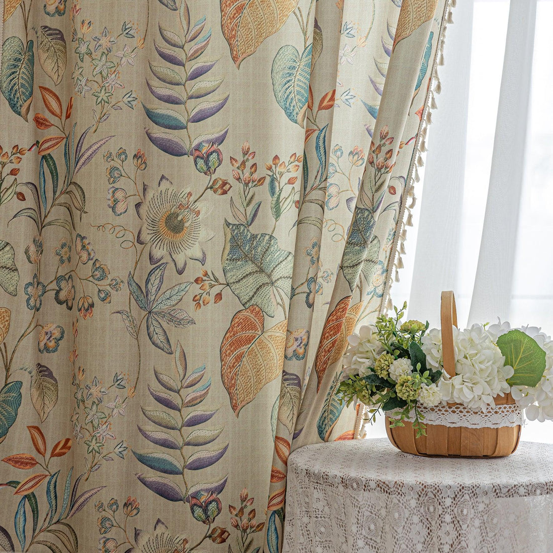 Elegant botanical curtain with a soft beige base, featuring hand-painted style floral and leaf patterns in warm earthy tones and muted pastels, finished with white tassel trim — perfect for bringing a fresh, nature-inspired charm to your home décor.