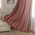 Bold tribal-inspired curtain with vibrant red, blue, and yellow geometric diamond patterns, accented by colorful tassel trim — perfect for adding a touch of ethnic charm and warmth to any bohemian or eclectic home décor.