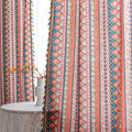 Bold tribal-inspired curtain with vibrant red, blue, and yellow geometric diamond patterns, accented by colorful tassel trim — perfect for adding a touch of ethnic charm and warmth to any bohemian or eclectic home décor.