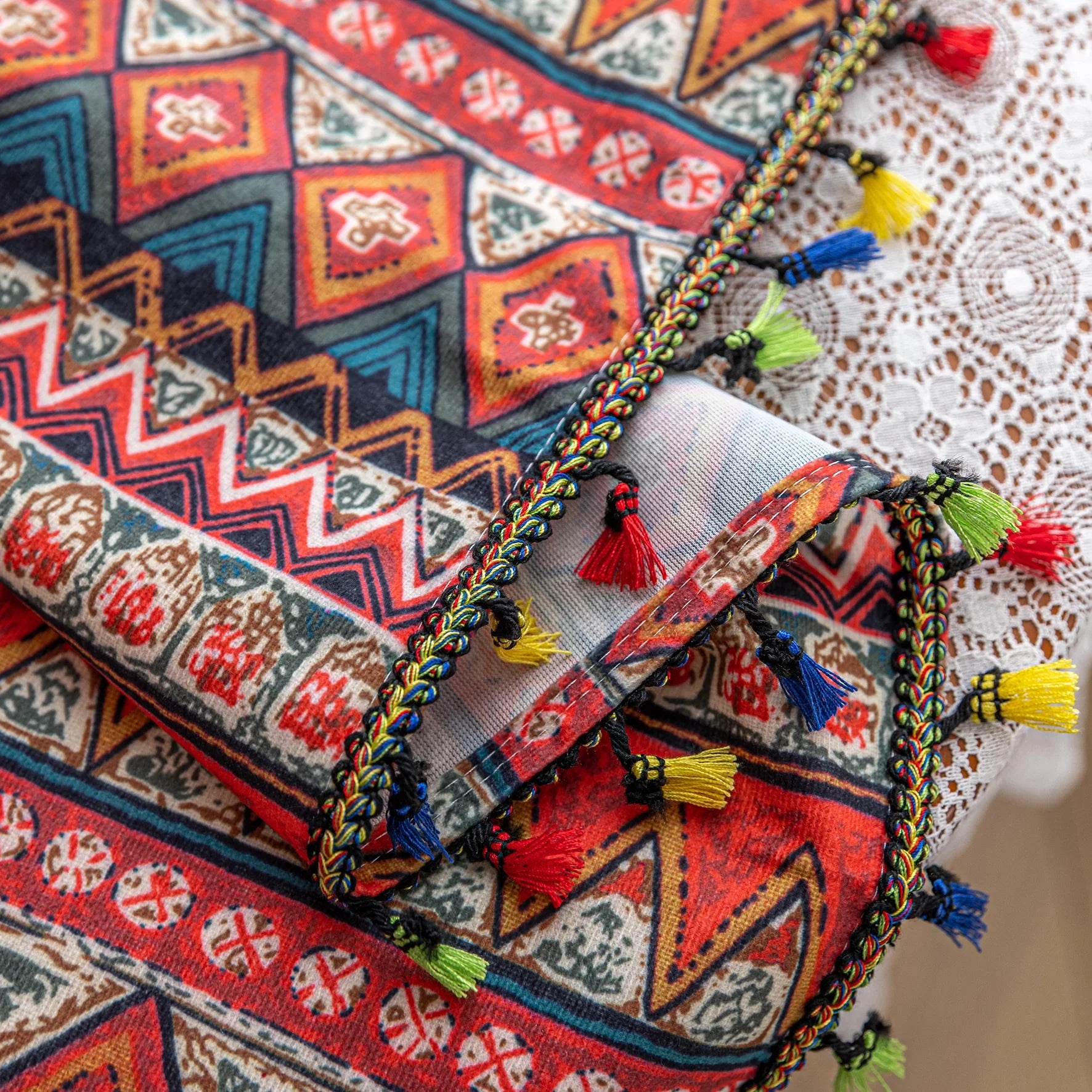 Bold tribal-inspired curtain with vibrant red, blue, and yellow geometric diamond patterns, accented by colorful tassel trim — perfect for adding a touch of ethnic charm and warmth to any bohemian or eclectic home décor.