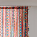 Bold tribal-inspired curtain with vibrant red, blue, and yellow geometric diamond patterns, accented by colorful tassel trim — perfect for adding a touch of ethnic charm and warmth to any bohemian or eclectic home décor.