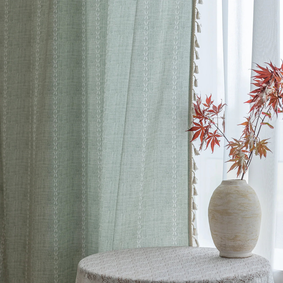 Minimalist sage green curtain with subtle vertical white embroidery and delicate tassel edging — perfect for creating a fresh, airy, and elegant atmosphere in any living room, bedroom, or dining space.