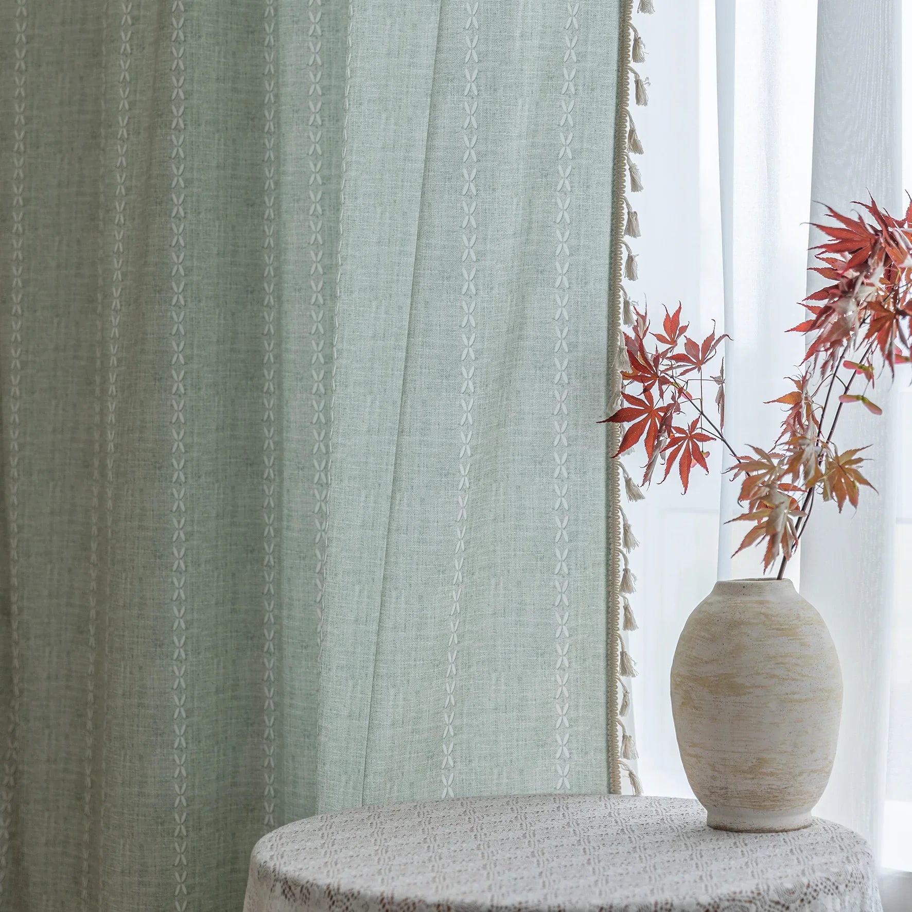 Minimalist sage green curtain with subtle vertical white embroidery and delicate tassel edging — perfect for creating a fresh, airy, and elegant atmosphere in any living room, bedroom, or dining space.
