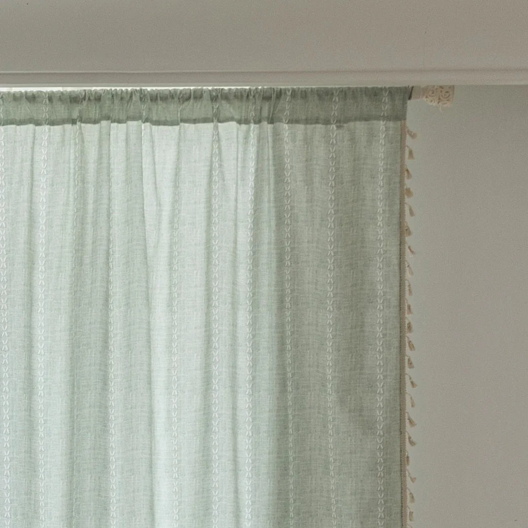 Minimalist sage green curtain with subtle vertical white embroidery and delicate tassel edging — perfect for creating a fresh, airy, and elegant atmosphere in any living room, bedroom, or dining space.