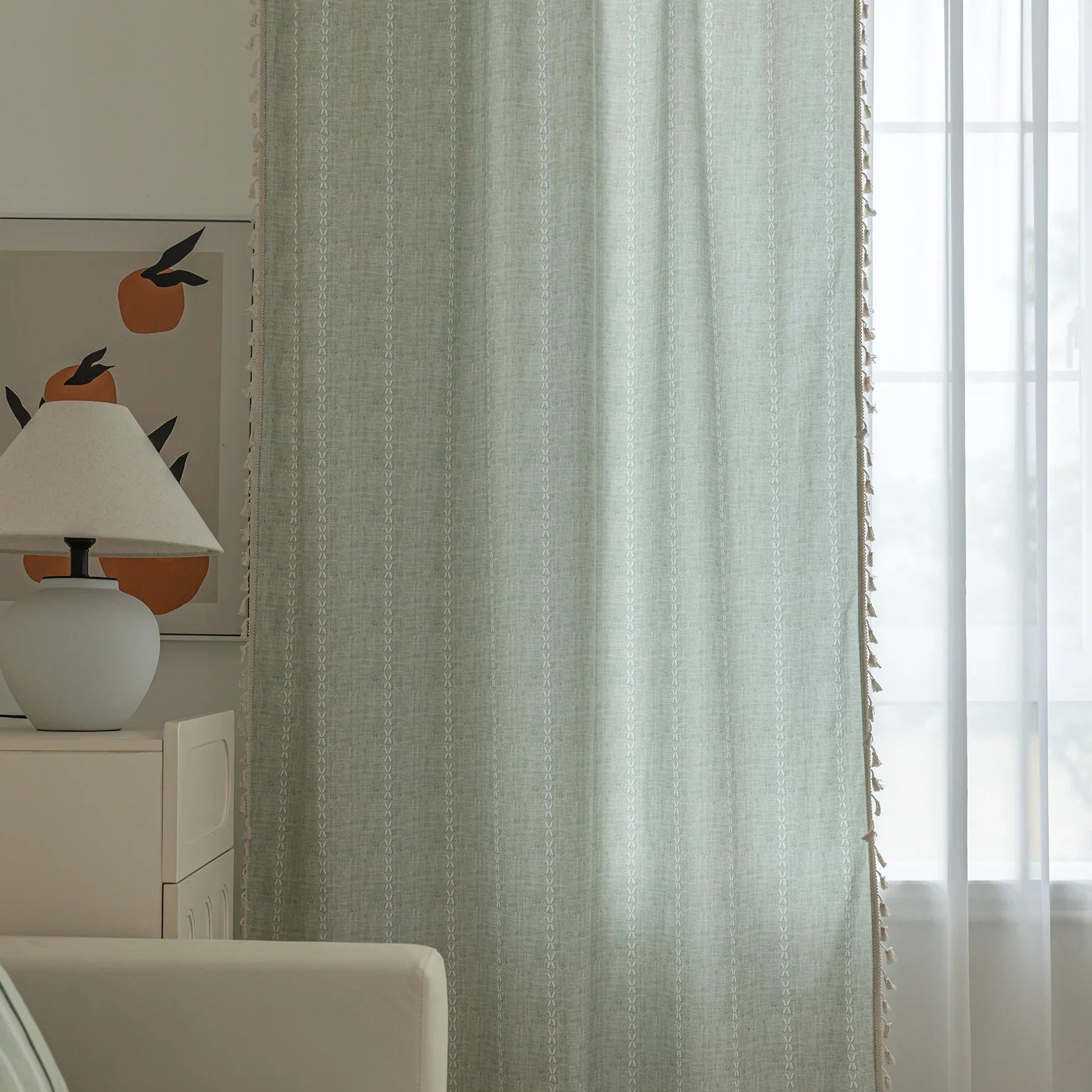 Minimalist sage green curtain with subtle vertical white embroidery and delicate tassel edging — perfect for creating a fresh, airy, and elegant atmosphere in any living room, bedroom, or dining space.