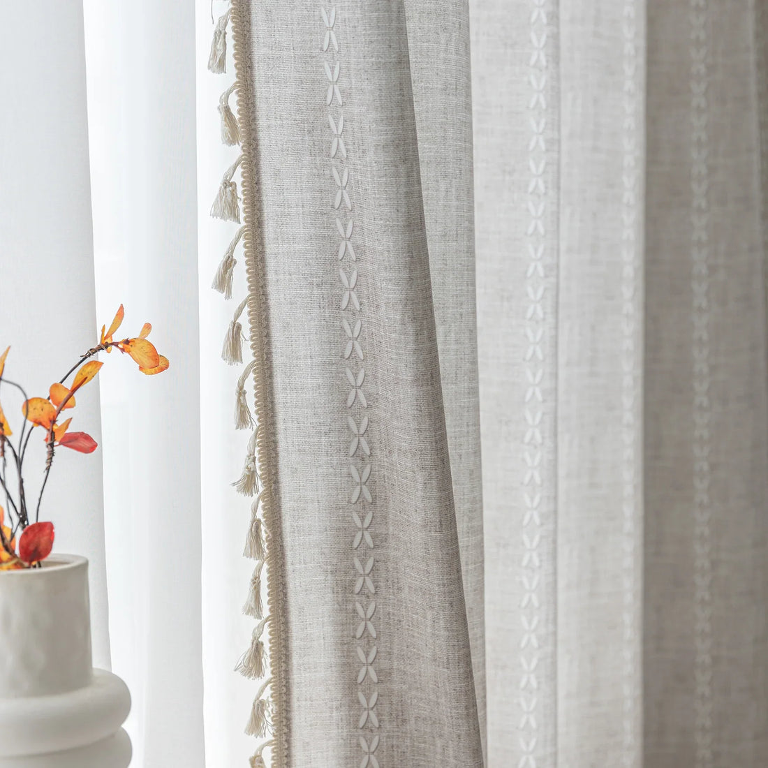Elegant beige curtain with subtle vertical white embroidery and soft tassel trim — a versatile and timeless design that adds warmth, texture, and understated sophistication to any room decor.