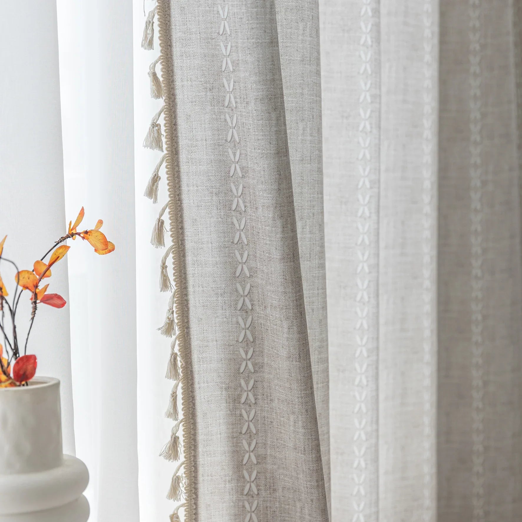 Elegant beige curtain with subtle vertical white embroidery and soft tassel trim — a versatile and timeless design that adds warmth, texture, and understated sophistication to any room decor.