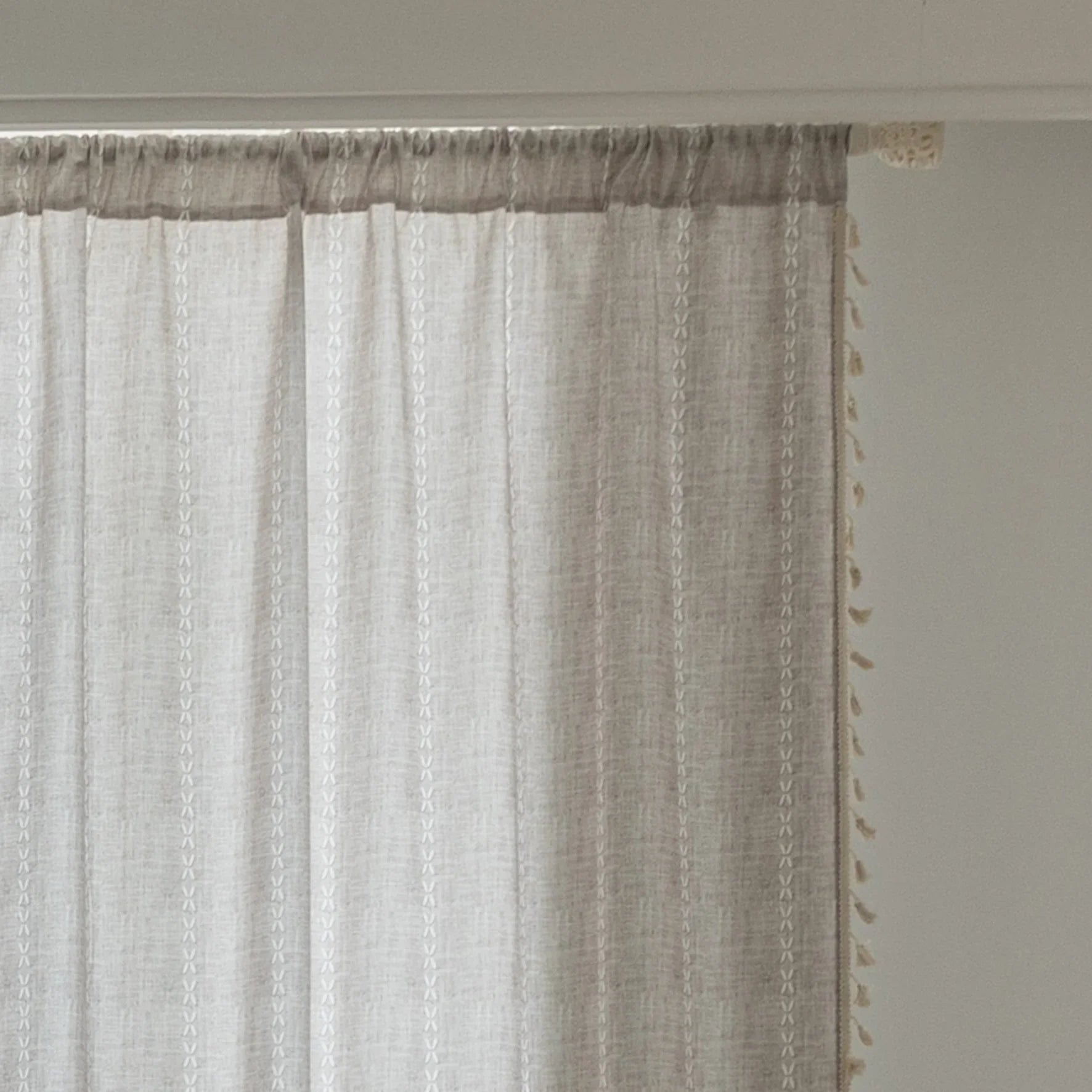 Elegant beige curtain with subtle vertical white embroidery and soft tassel trim — a versatile and timeless design that adds warmth, texture, and understated sophistication to any room decor.