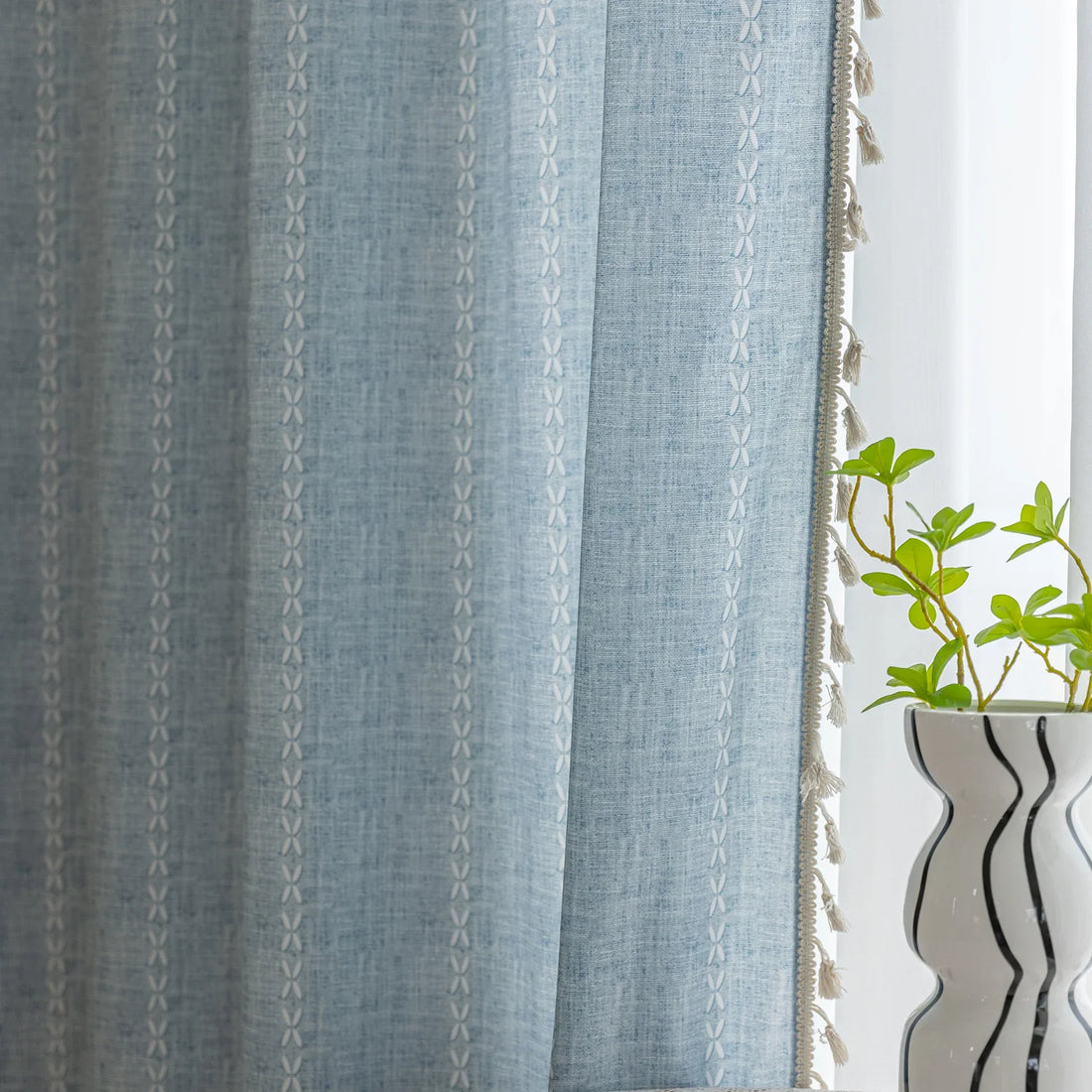 Light blue curtain with delicate vertical white embroidery and charming tassel edging — perfect for creating a fresh, airy, and stylish atmosphere in any living space.