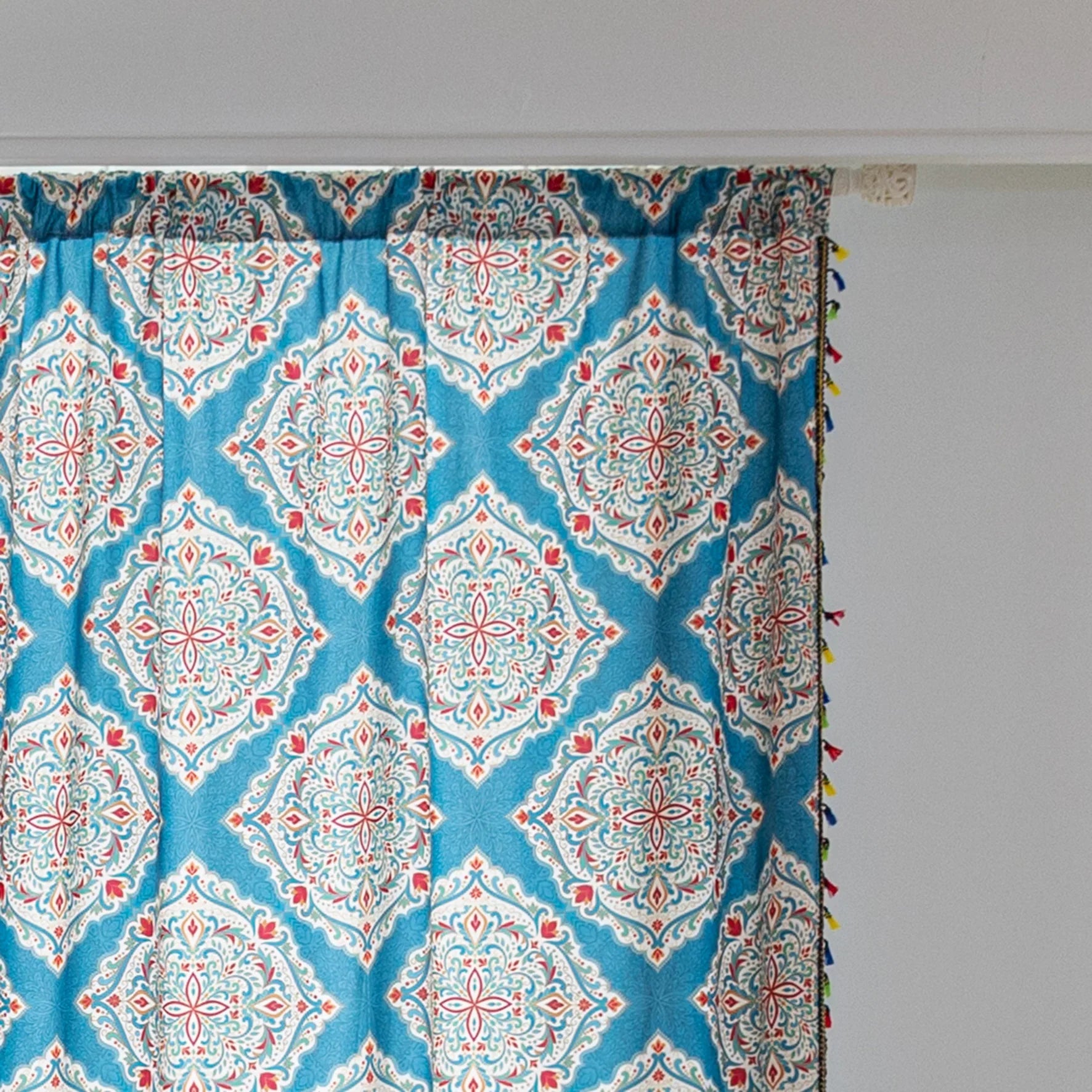 Elegant bohemian curtain featuring intricate Moroccan-inspired patterns in vibrant red, green, and gold on a rich turquoise background, finished with colorful tassel trim — perfect for adding a bold, artistic, and exotic flair to your home decor.