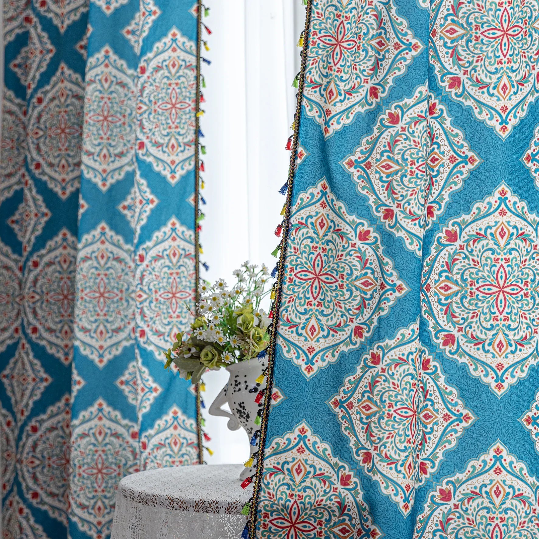 Elegant bohemian curtain featuring intricate Moroccan-inspired patterns in vibrant red, green, and gold on a rich turquoise background, finished with colorful tassel trim — perfect for adding a bold, artistic, and exotic flair to your home decor.