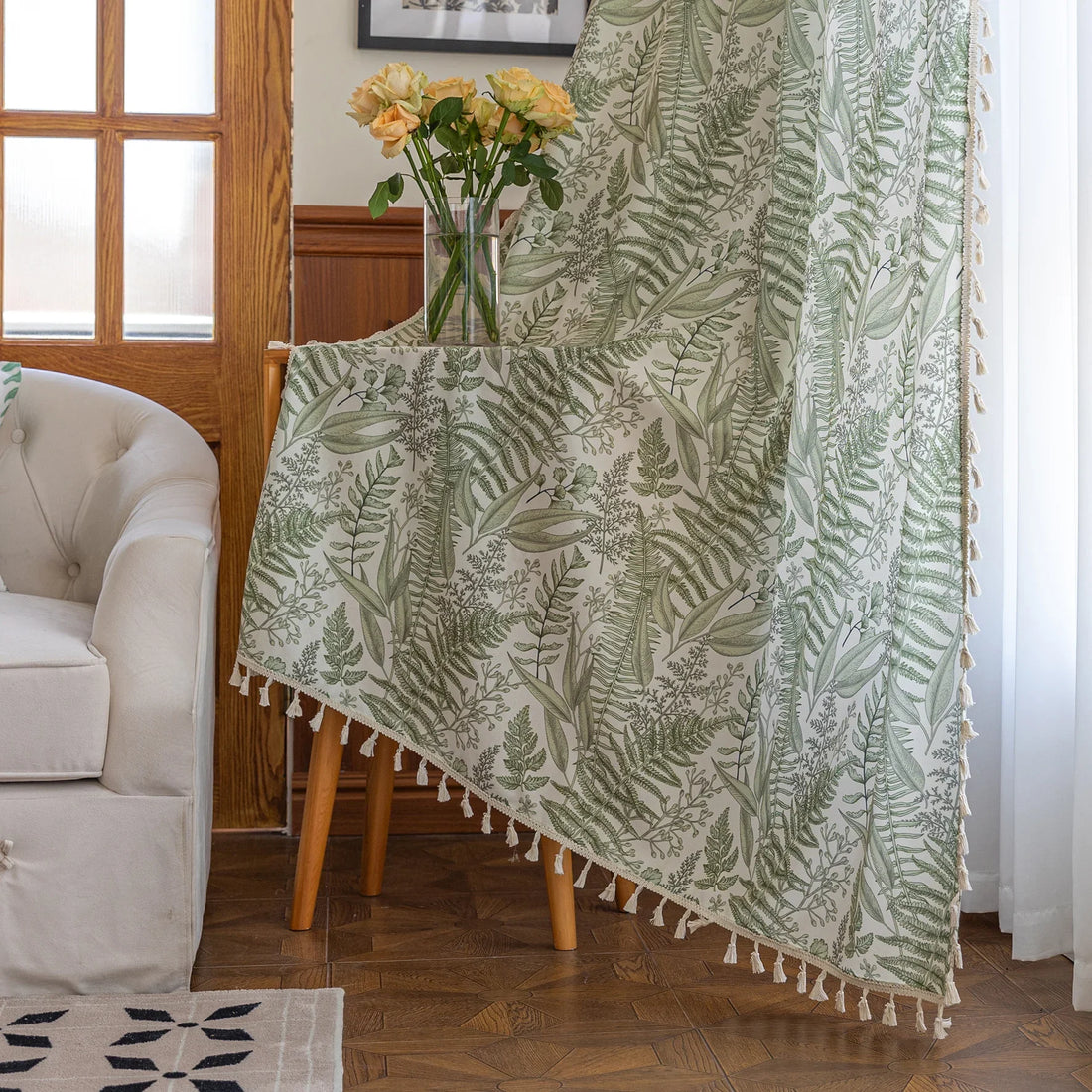 Botanical-themed curtain featuring lush green fern and leaf prints on a soft beige background, accented with delicate tassel trim — perfect for bringing a fresh, natural, and calming touch to any living space.