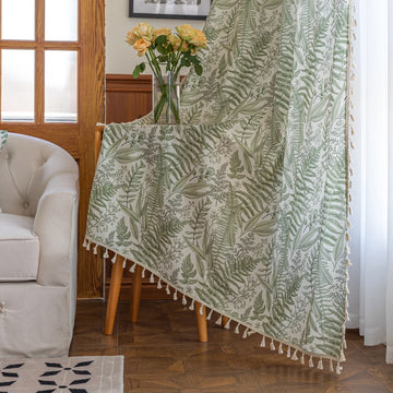 Botanical-themed curtain featuring lush green fern and leaf prints on a soft beige background, accented with delicate tassel trim — perfect for bringing a fresh, natural, and calming touch to any living space.