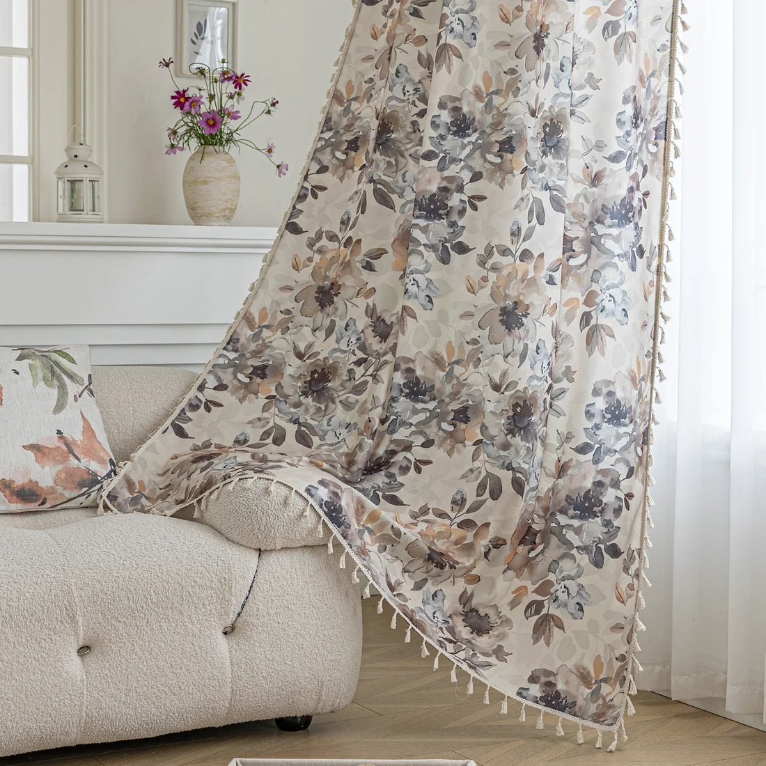 Chic beige curtain with soft watercolor-style floral prints in earthy tones of brown, taupe, and grey, accented with delicate tassel trim — ideal for adding a warm, elegant, and nature-inspired touch to any living space.