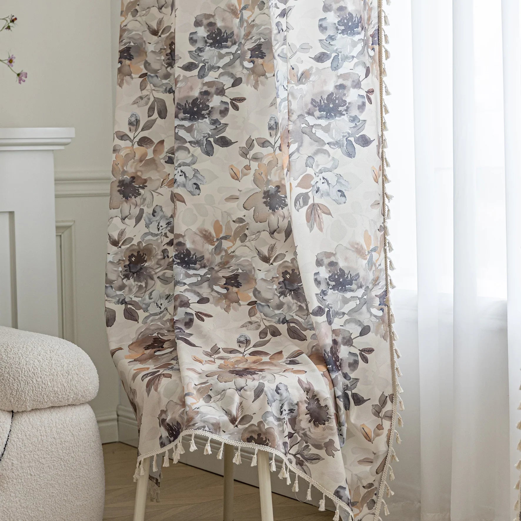 Chic beige curtain with soft watercolor-style floral prints in earthy tones of brown, taupe, and grey, accented with delicate tassel trim — ideal for adding a warm, elegant, and nature-inspired touch to any living space.