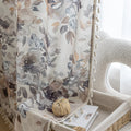 Chic beige curtain with soft watercolor-style floral prints in earthy tones of brown, taupe, and grey, accented with delicate tassel trim — ideal for adding a warm, elegant, and nature-inspired touch to any living space.