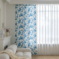 Elegant white curtain with soft watercolor-style blue floral prints, finished with delicate tassel trim — perfect for adding a fresh, airy, and romantic touch to your living room, bedroom, or cozy reading nook.